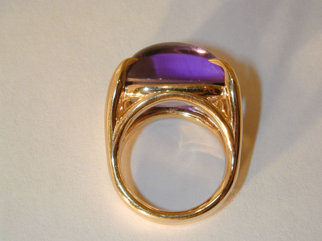 18KT yellow gold set with a sugarloaf-cut amethyst weighing 22.01cts. Signed Meriwether. Size 6 1/2.