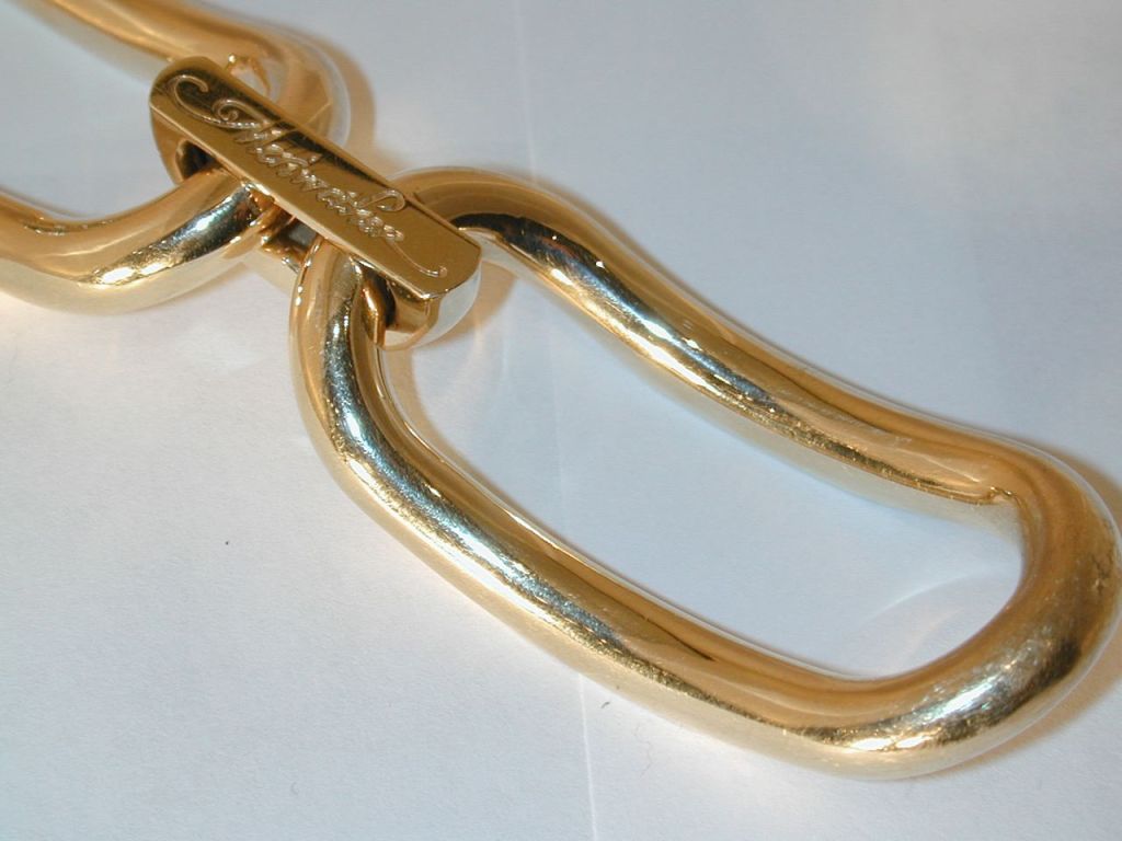 18KT yellow gold link bracelet consisting of three large rectangular links connected by 3 domed flat-topped links. 
Signed Meriwether
7.75