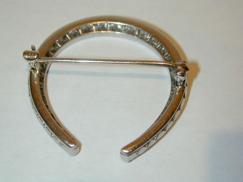 14KT white gold diamond horseshoe-shaped brooch having approximately 2.33cts of round Old European cut diamonds.
