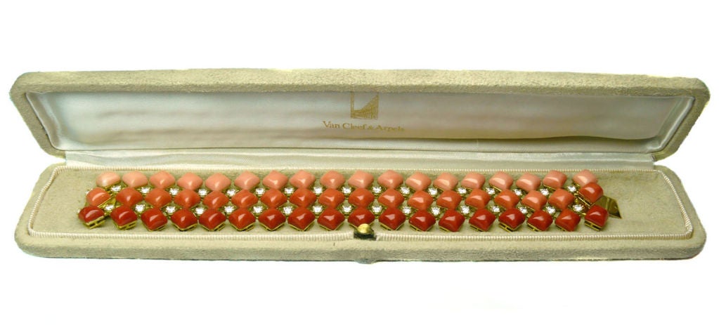 Offered as part of a suite of coral and diamond jewelry by Van Cleef and Arpels. The bracelet is designed as three lines of oxblood, salmon and angel skin square-shaped cabochon corals with brilliant-cut diamond spacers. A ring and a pair of ear