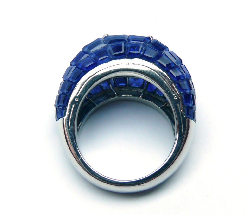 Bombe design ring set with an emerald cut diamond weighing approximately 3.35ct, framed by calibre cut sapphires weighing approximately 26.00ct.  Signed Van Cleef & Arpels, numbered N.Y. 45141