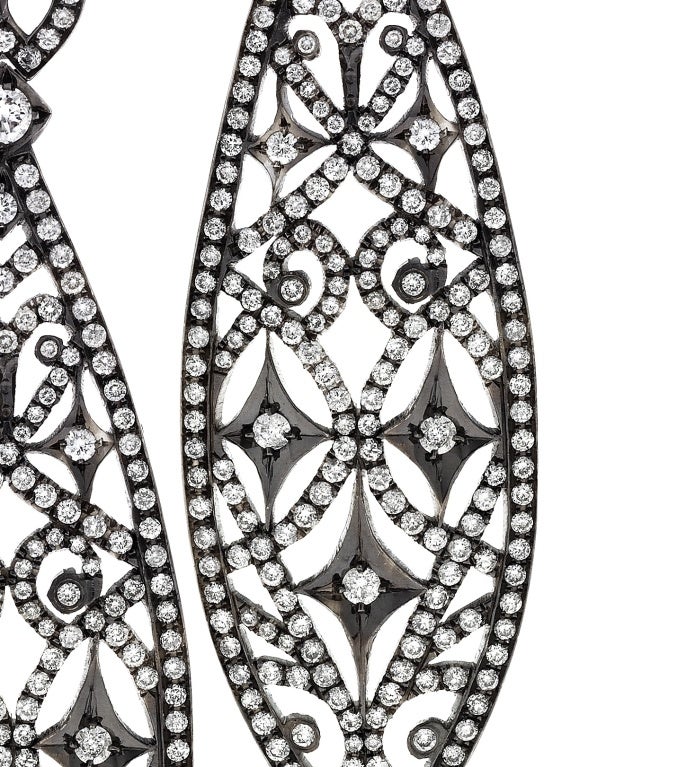 A hand crafted pair of earrings in 18k white gold set with diamonds. 5.17 carat total weight diamonds G-H color VS clarity. 

Gold weight - 11.4 dwt

Black rhodium finish.