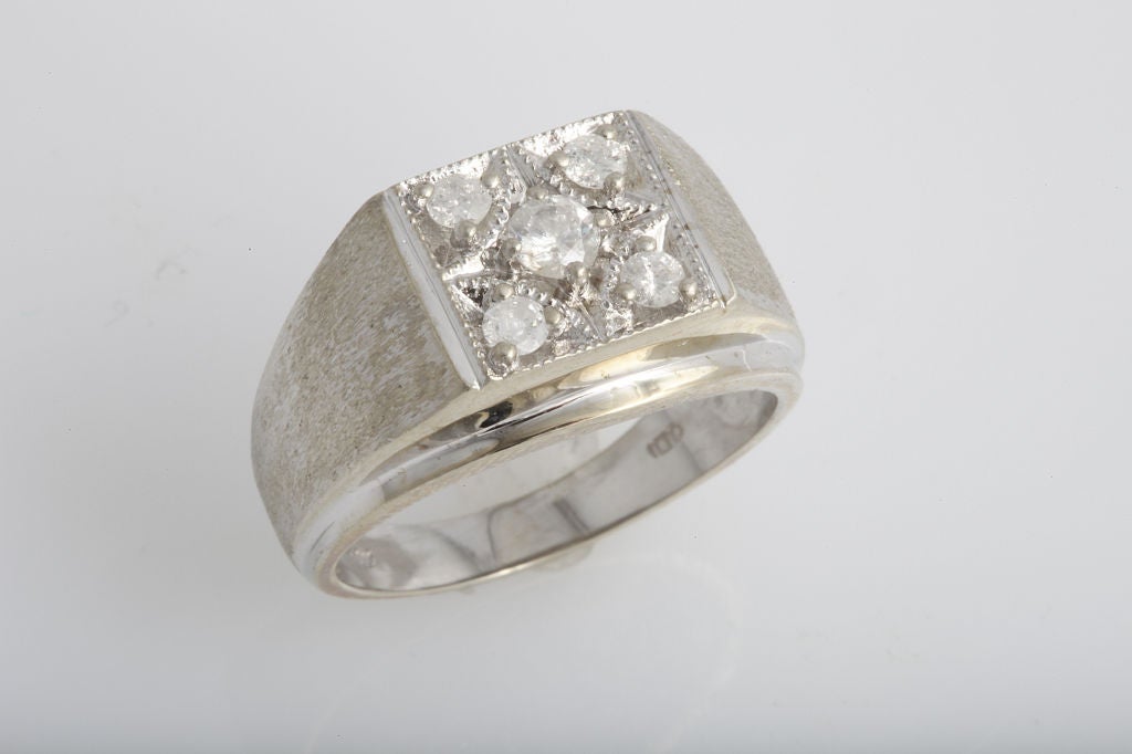 A fine diamond ring centrally set with 4 round brilliant cut diamonds weighing aprrox. .60cts total in a Florentine finished 14K whie gold hand made mounting weighing 5.00dwt.<br />
<br />
Ring Size: 9 1/2