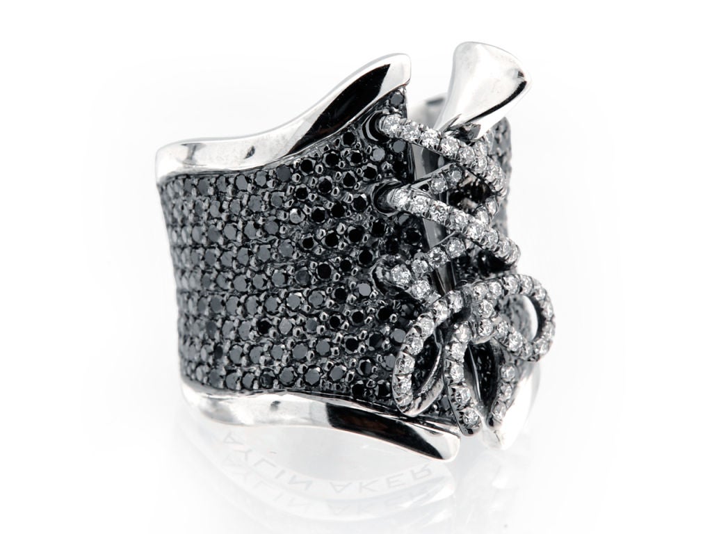 An interesting corset ring, pave set with 350 black diamonds weighing 2.50 ct and white diamonds on the bow weighing 0.50 ct. The ring is beautifully made with immaculate detail and dimensions. The bow is 3-dimensional and ads a whimsical touch.
