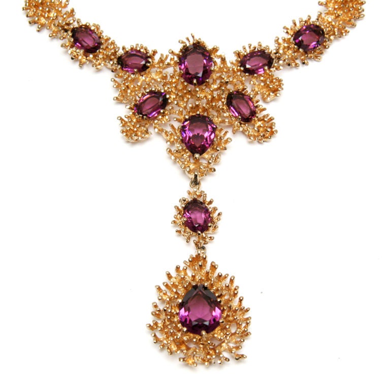 Signed Panetta textured gold toned necklace with faceted amethyst colored crystals and matching earrings.
