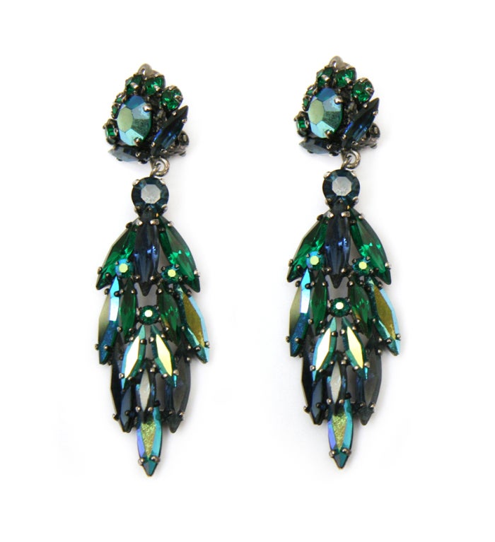 Signed Sherman dangly earrings composed of dark green, deep blue, and teal aurora borealis Swarovski crystals.