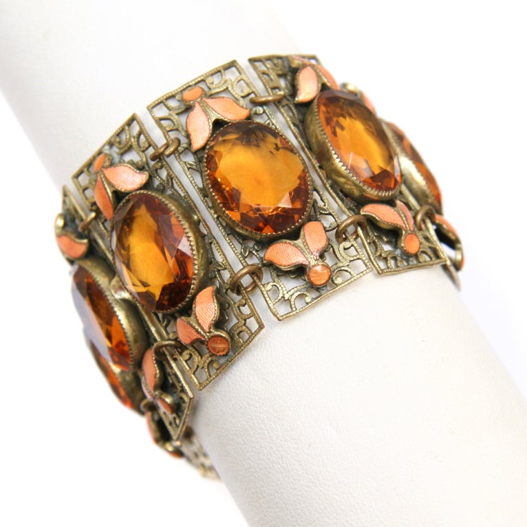 Czech bracelet featuring eight links with oval amber colored crystals and orange enamel accents