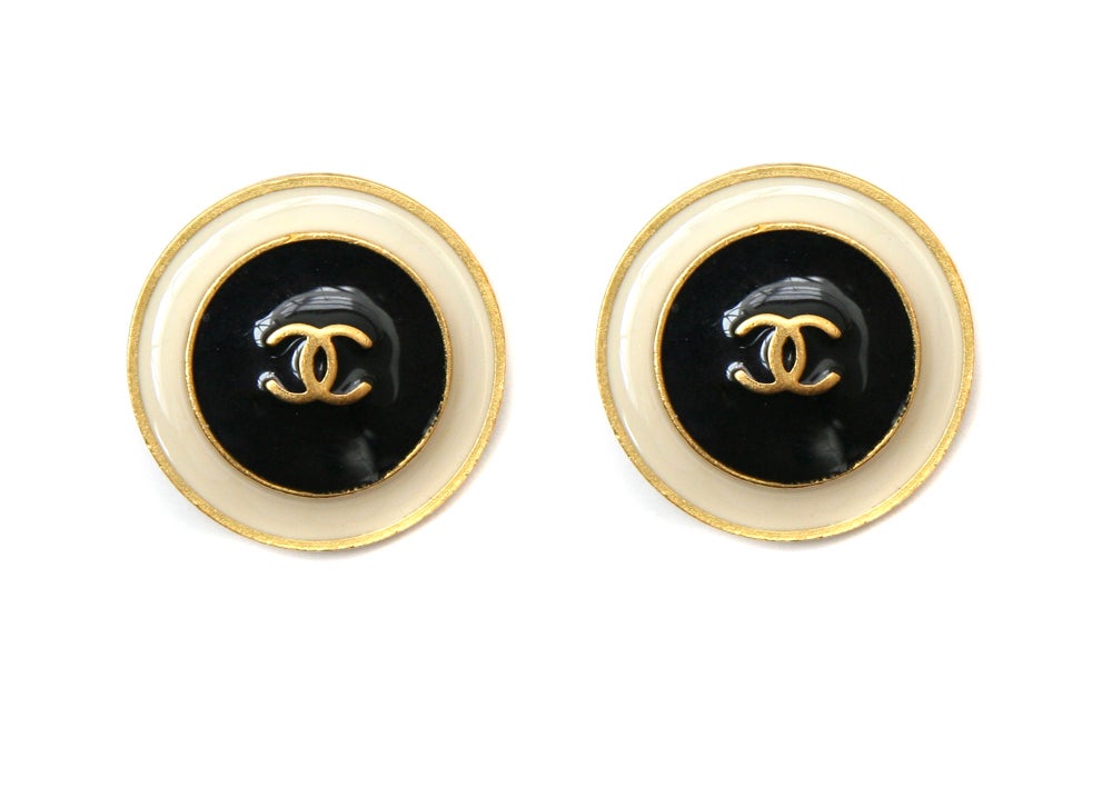 Signed Chanel button earrings with black and cream enamelling and gold toned metal borders. Circa 1995.