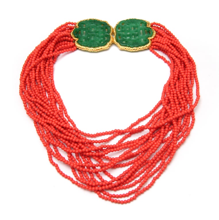 Signed KJL coral colored multi-stand necklace with carved jadeite chinoiserie clasp.