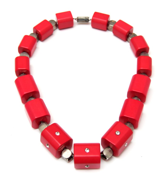 Signed Alexandra Coster necklace with large red plastic beads, silver toned metal spacer beads, and diamante accents.