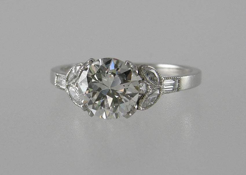 Gorgeous Art Deco engagement ring.  The center is 1.41ct K-VS1 with an Old European cut with 4 marquise and 2 baguette side diamonds that form a 