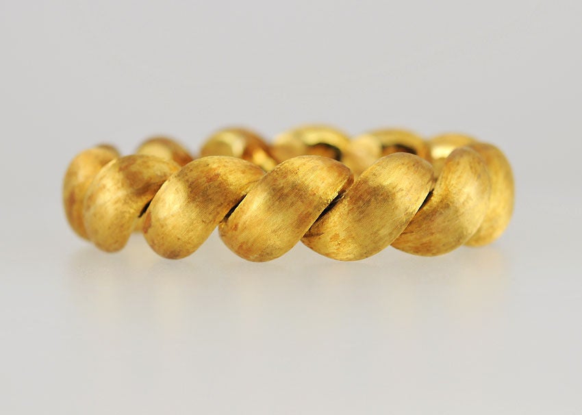 Couldn't you just see Sophia Loren wearing this in San Tropez arms tanned,sipping a cocktail? This bracelet has such a beautiful finish and such great style in rich 18K yellow gold, that you'll wonder how you ever lived without it!