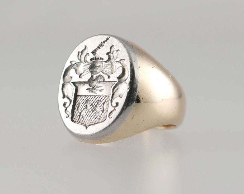 This is a beautifully carved and very heavy crest ring, which is 14k with a Platinum top. The crest is elaborate, with a knight in profile,a bird, and two griffins on a shield. It is signed Tiffany.