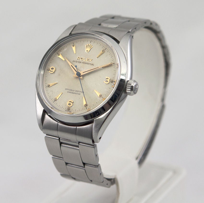Rolex stainless steel Oyster Perpetual wristwatch, Ref. 6564, circa 1962. This automatic watch has a 25 jewel movement, an acrylic crystal, and features an original light cream dial and gilt dagger and Arabic numerals. The case is 34mm and looks