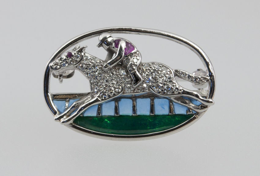 Really amazing pin for that male or a female horse racing enthusiast.Would make a fantastic gift.   Platinum piqué a jour horse and rider, filled with diamonds, enamel accents and racing toward the finish line.  it's a winner!