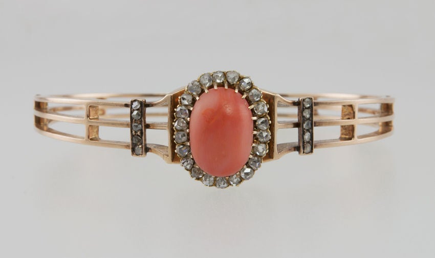14k gold Victorian bangle, with two open sections that meet in the center with rose cut diamonds around coral. On each side is a section of rose cut diamonds. Very lovely period piece.