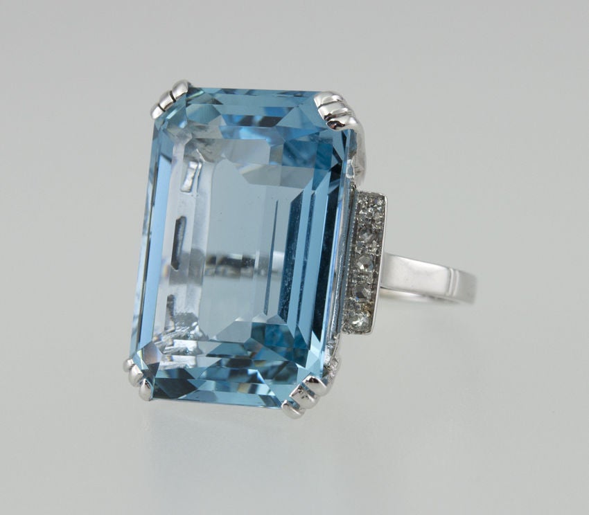 This giant Aqua is the perfect color! I'm not kidding!  Even the photograph doesn't do it justice. A perfect sky blue, emerald cut, approximately 15 carats. It is set in  platinum with four diamonds as an accent down each side...very Deco.