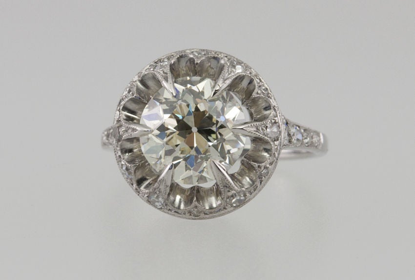 This very interesting and beautiful ring has a center 2.70 ct old european cut diamond with an EGL certificate N-VS1. It is suspended in the mounting that is filled with numerous single cut diamonds, and held with 6 spike prongs. The gallery is very