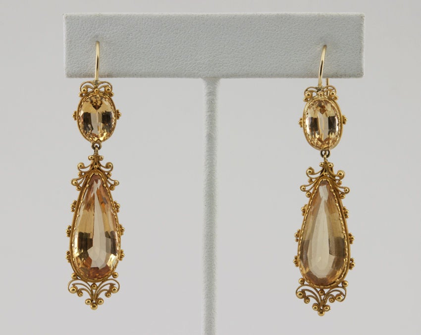 These long drop victorian earrings have such beautiful and elaborate gold scroll and bead work.  All hand done in 18k, in the Etruscan revival style that was popular at the time.  The citrines are faceted and lively.  These are really beautiful.