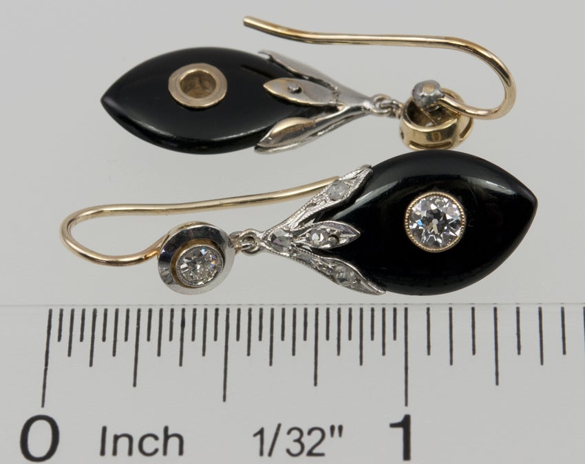 I really like these earrings!  I think because you could wear these every day and they wouldn't be too much, but they would also be a great evening earring!  Love that! Anyway, the top has a bezel set diamond,leading to a cap of rose cuts on a