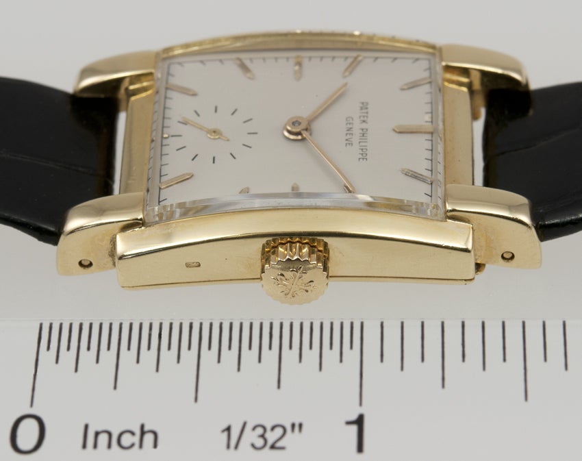 This mens dress watch from Patek Philippe is in a thick heavy squared off 18k yellow gold case,with stick markers and subsidiary seconds at the six o'clock position ,it has a mechanical wind movement ref# 2443.