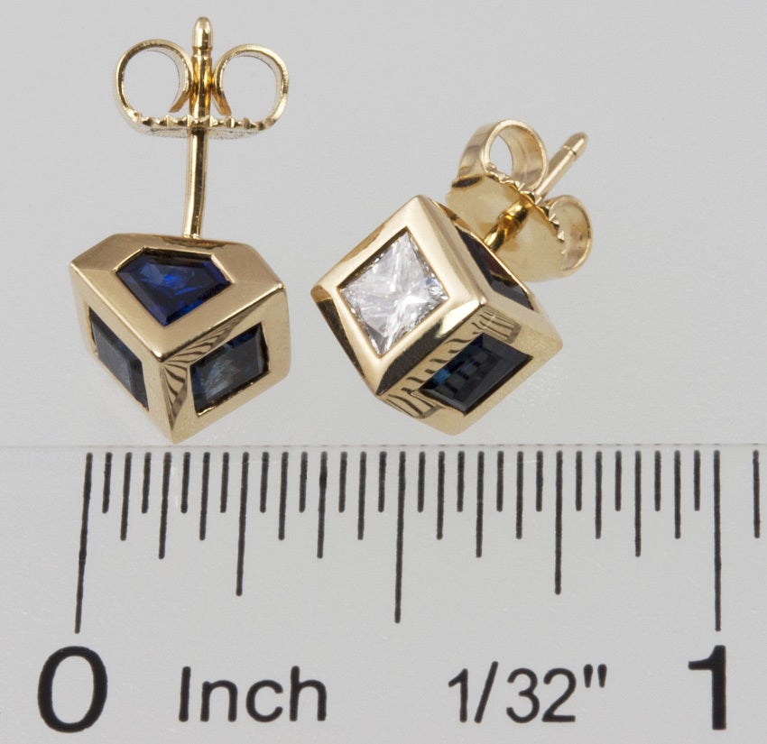 These cube earrings are very attractive.  They have five sapphires, two are square cuts, three are trapezoid cuts. There is one radiant cut diamond, with a total diamond weight of .80ct. They come in the original box.