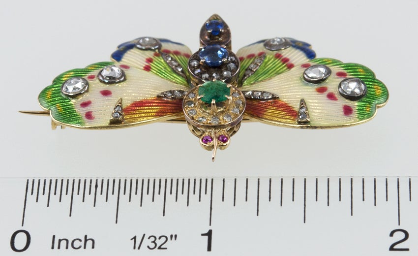 This is one of the prettiest butterfly brooches I've seen.  Amazing enamel work with accents filled with rose cut diamonds. The body has two sapphires, two emeralds and cabochon ruby eyes.