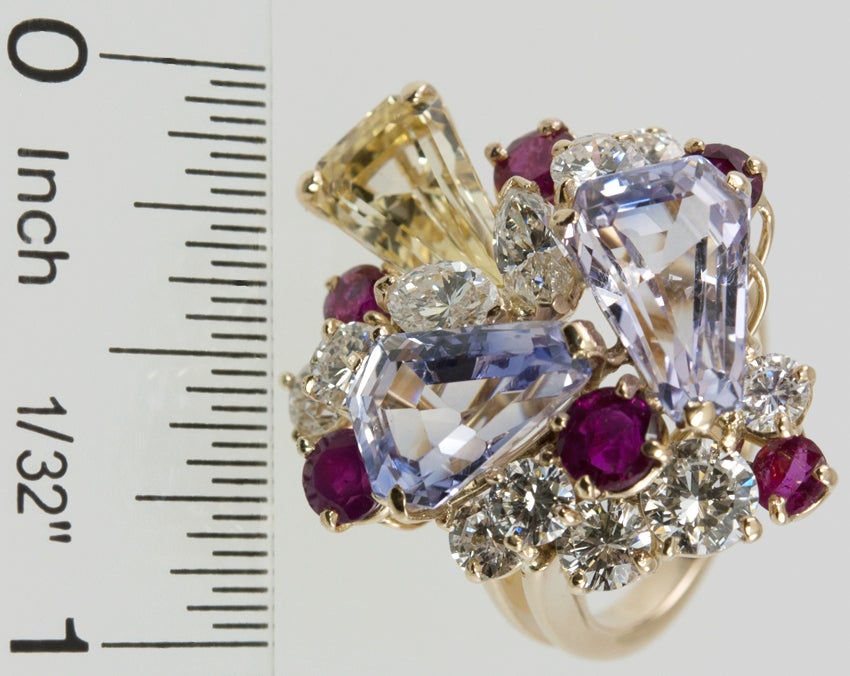 This is a CRAZY jumble of wonderfulness!!  Approximately 3cts of beautiful diamonds, and three sapphires, one lavender,one light blue and one yellow.  Then to top it off, six rubies!  And signed OSCAR HEYMAN !!