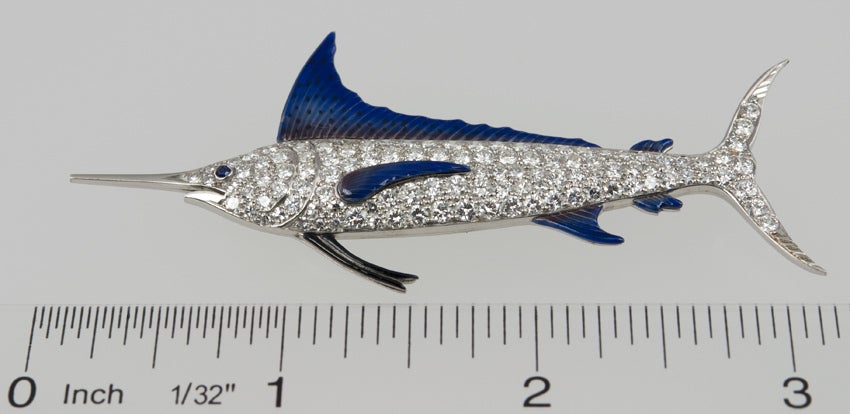 A very realistic large Marlin fish brooch in platinum from circa 1920s.  This brooch features 4 carats of single and full cut diamonds with a sapphire eye and beautiful blue and black enamel on the fins.  

This brooch measures approximately 3.09