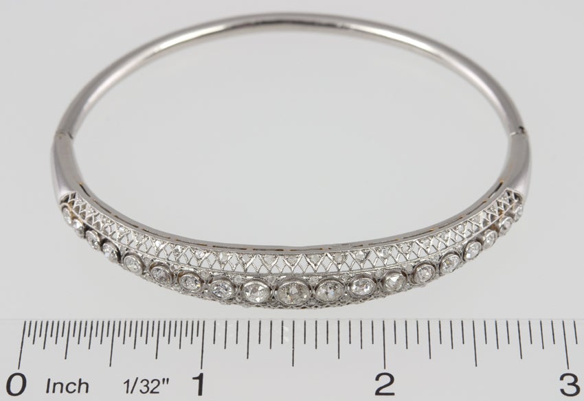 Platinum Edwardian bangle with that gorgeous lacy filagree that is filled with rose cut diamonds.  The center has 19 old european cut diamonds in bezels in descending size with a total weight of 2.5 carats. French hallmarks.