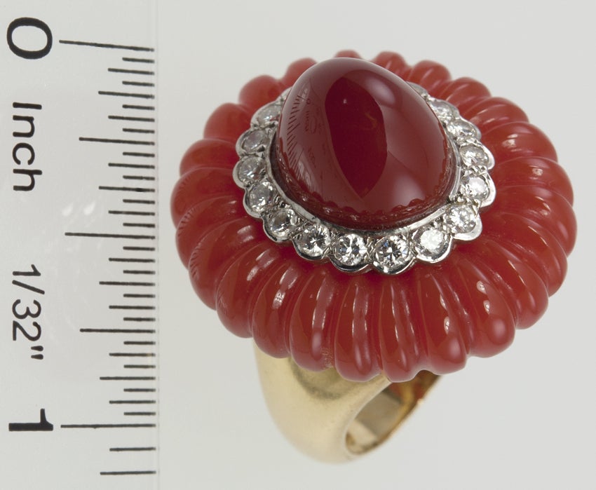 This is such a fantastic,glamourous ring! You have to have a lot of style to carry this off! Carnelian cut in a fluted design, with a ring of full cut diamonds, surrounding a center bullet cut carnelian.Very Chic!