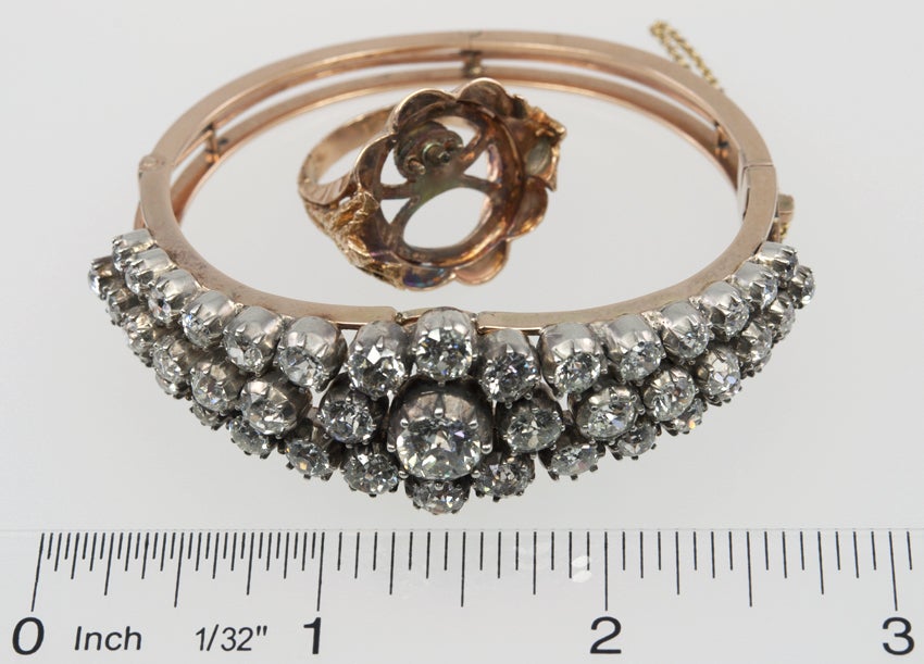 18k Gold bangle filled with old european cut diamonds set in silver.  The center has screw posts for a circular piece, also silver with 9 rose cut diamonds,that can become the center of the bangle, or be worn as a ring.  The total diamond weight for