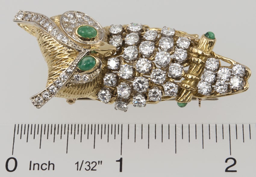 This handsome fellow is covered with 4 carats of diamonds, with cabachon emerald eyes and on the ends of his perch.  He is on a double clip for a coat or scarf, and the CARTIER signature and numbers are on a bar under the clip and were impossible to