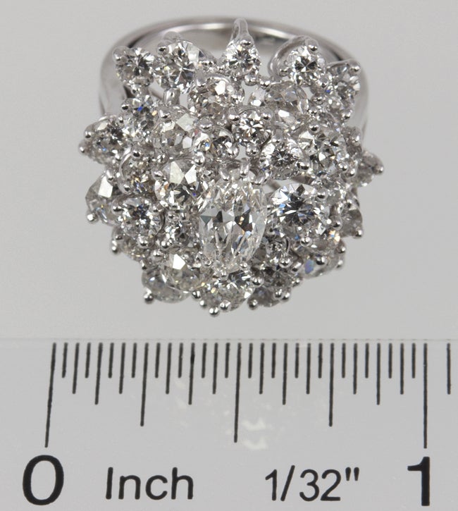 Platinum cluster ring with 4 carats of round brilliant diamonds with a .50ct center marquise cut diamond. This is a real eye catcher!