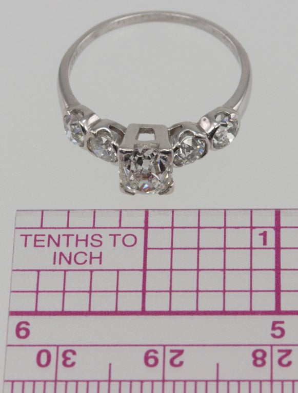 Platinum ring with a center cushion cut diamond equaling 0.97cts. I-VS2 with an EGL certificate. It is set simply with four corner prongs and 4 Old European Cut side diamonds, each approximately 0.18 carats for an additional 0.72 carats in diamond
