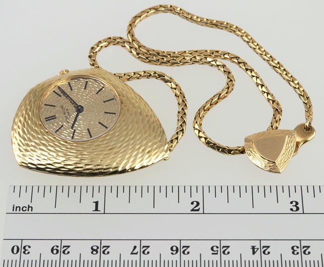 18k very groovy textured gold PATEK PHILLIPE  asymmetrical pocket watch, known as the Ricochet, with manual-wind movement, gold textured dial on an attached box link gold chain with belt loop clip.
