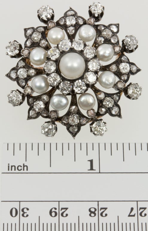 Silver top with a gold back, this sunburst brooch has a beautiful arrangement of old european, and rose cut diamonds, about 4 carats worth! and and eight pearls to finish off the look!