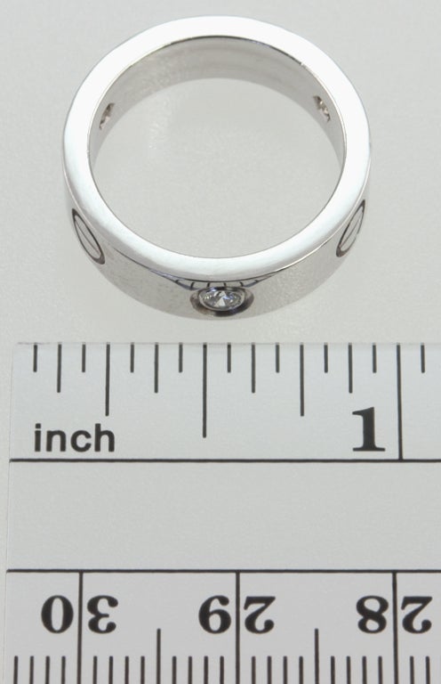 18k white gold CARTIER LOVE band with three bezel set  beautiful quality diamonds equaling .21 carats total.  Size 6  not sizable, a great addition to a stack!