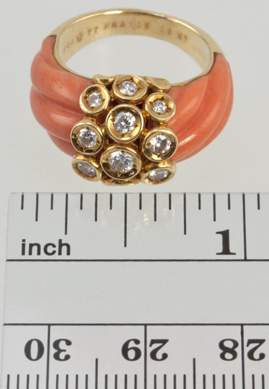 18k Sassy little fluted coral ring with round brilliant diamonds in bezels across the top equaling one carat total weight.  It is signed VCA and dated 1977.