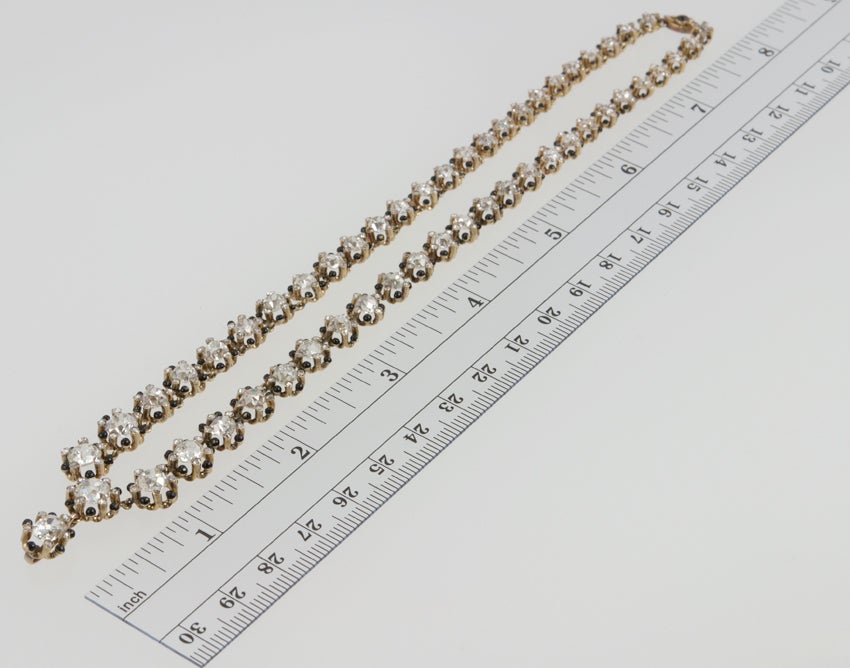 A stunning Victorian diamond choker necklace in 18 karat yellow gold. This necklace features 52 Old Mine Cut diamonds for a total diamond weight of approximately 17 carats! The cushion shaped diamonds are approximately I-J in color and VS-SI in