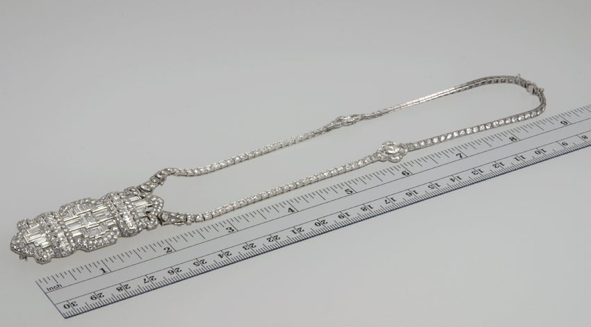 Platinum diamond necklace with a mix of old cuts, single cut and two marquise cut diamonds. The approximate total diamond weight on the necklace is 7.68cts. It is attached to the Deco bar pin that has a mix of baguette, pear and round diamonds with