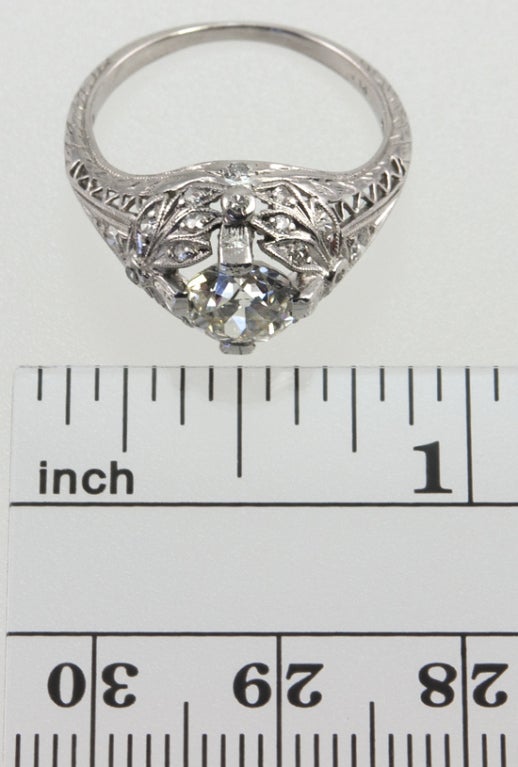 This is a stunning ring!  The mounting has leaves and bows and engraving, and filled with single cut diamonds! The center old european cut center diamond is 1.02 carats, K-VS1 with an EGL certificate. This is a dream ring!