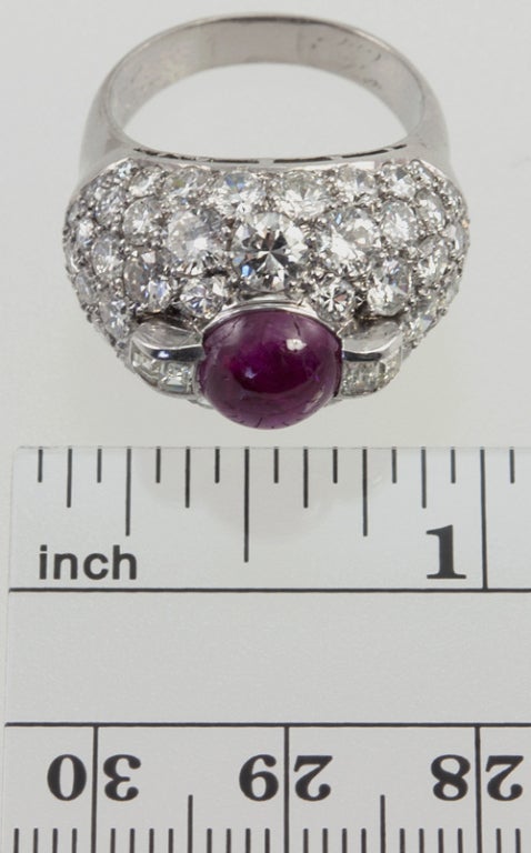 Platinum dome diamond cluster ring from circa 1940s with a center 2 carat cabochon ruby.  The dome is paved with 70 round brilliant diamonds and 4 baguette diamonds for a total approximate diamond weight of 4 carats.

Currently a US size 6.5 and
