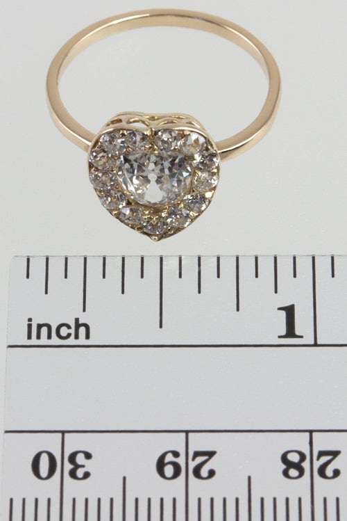 This darling heart shape ring has an appoximately 1.25ct old european cut diamond center that is approximately J-K, VS2.  There are 13 more old cut diamonds surrounding the center for a total carat weight of 2 carats.  There is beautiful open
