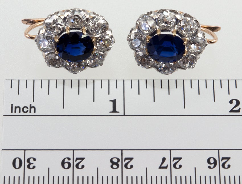 Platinum top/18k gold back old european cut diamond cluster earrings, with 5 carats total weight. The center old cut natural untreated sapphires are 