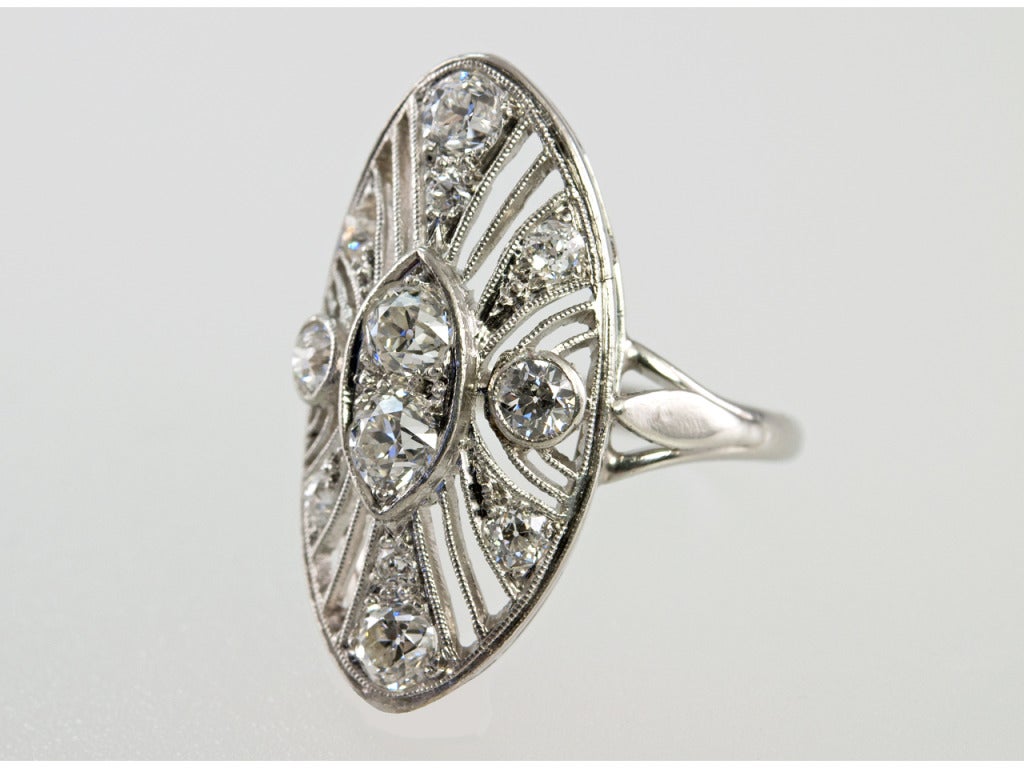 Platinum elongated oval ring filled with 1.50 carats of old european cut diamonds. It is highly cut out and slightly curved which makes it fit the finger so beautifully.