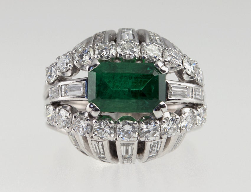 Emerald Cut Vintage 1950s Emerald and Diamond Bombe Platinum Cocktail Ring For Sale