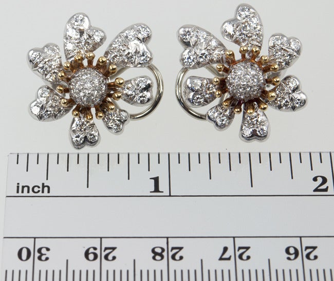 Platinum and 18k gold flowers paved with 4 carats total of incredible diamonds.  They are approximately G-H color and VS clarity.  A great pair of SCHLUMBERGER earrings are so difficult to find these days. These are really special!