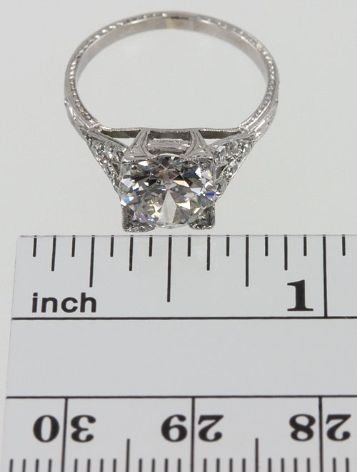 Platinum ring with a gorgeous split shank detail on the sides filled with diamonds, leading to a center old european cut diamond  set in corner prongs, weighing 1.88 carats J-SI1 with an EGL certificate.
There is also tons of engraving!