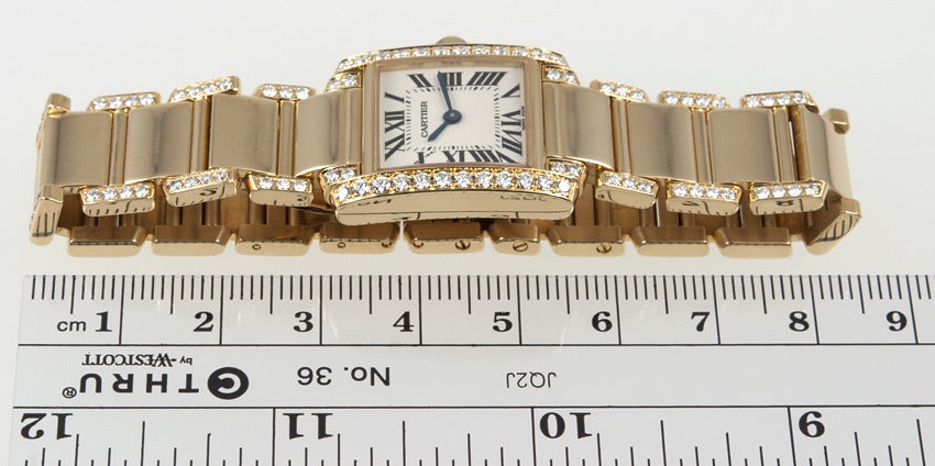 18k yellow gold lady's Cartier Tank Francaise wristwatch with factory diamond case and band. This watch is approximately five years old, with a quartz movement. 
Current retail on this watch is $ 40,250.